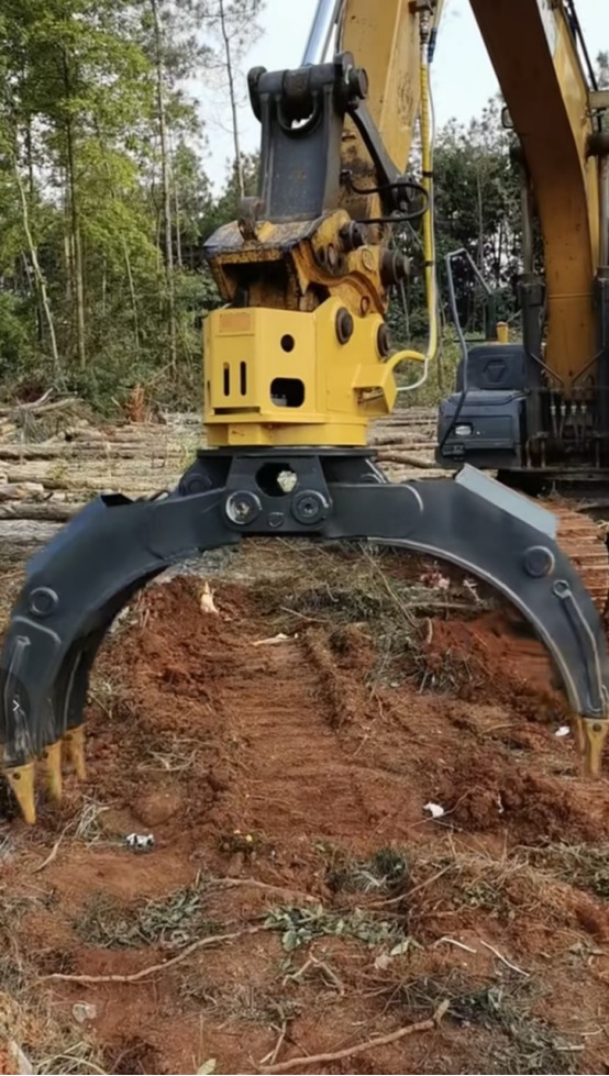 Excavator hydraulic log grapple working on forest site