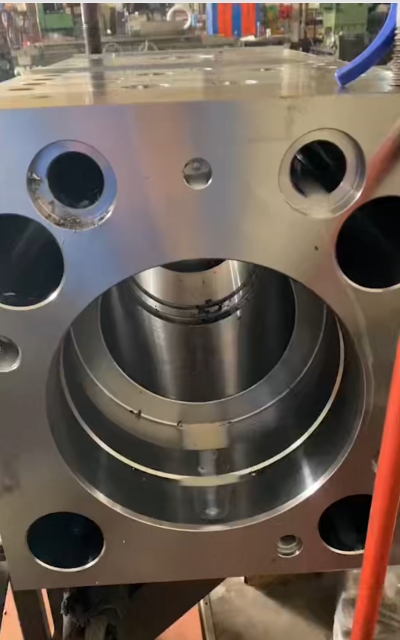 Close-up precision machined metal cylinder housing of hydraulic breaker main body